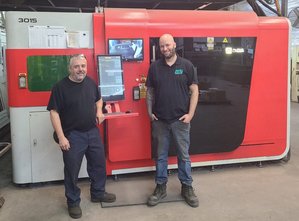 MSG Industries Vice-Presidents Olivier Samson (right), and Éric Gaudreau (left) in front of their laser cutting machine, which they use to cut parts for a broad range of industries